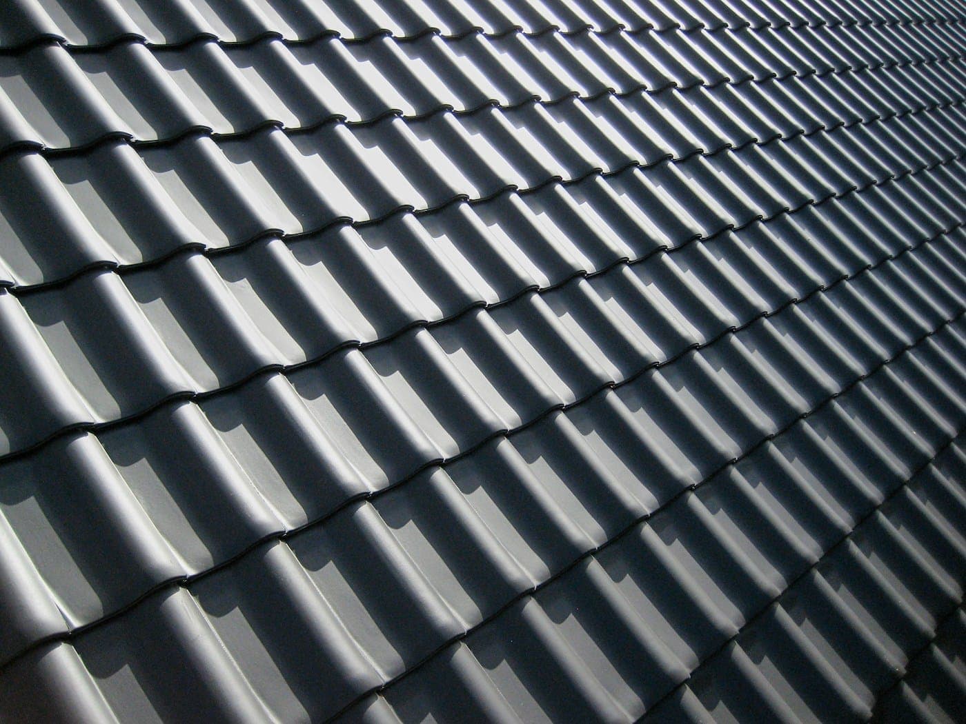 Dark metal tile roof after a full re-roof