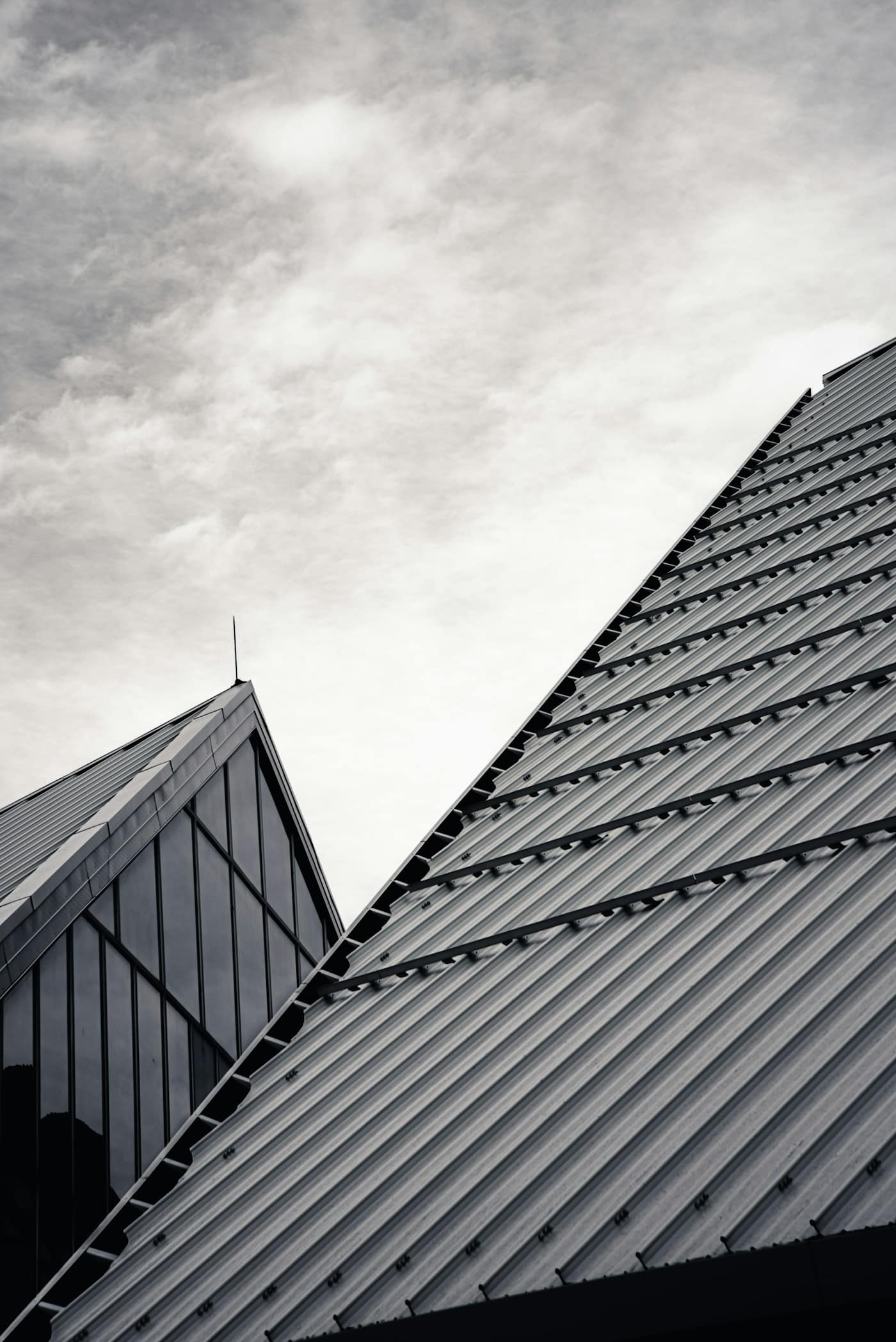 Angular dark metal rooflines on a completed build