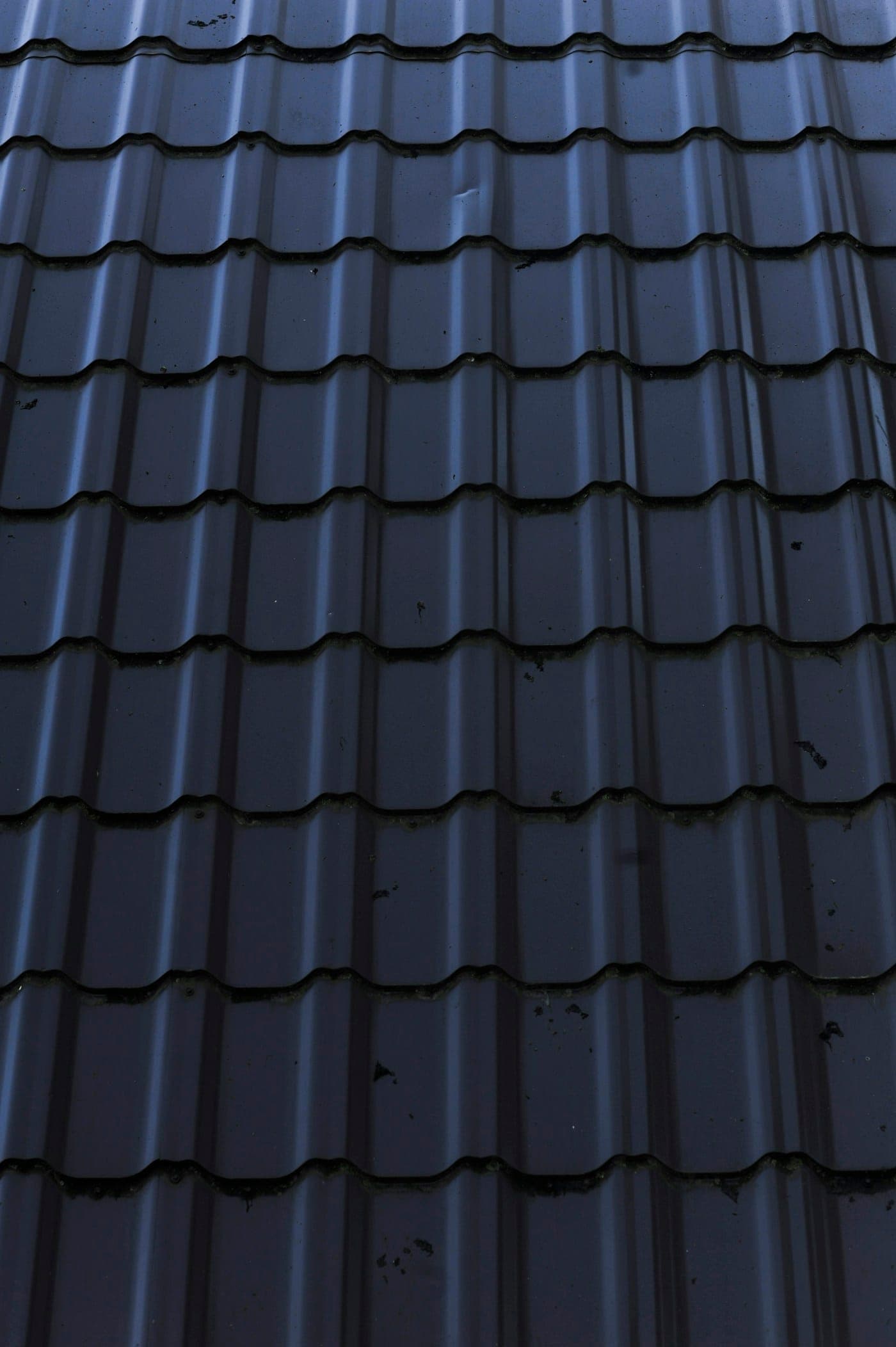 Dark metal tile roofing profile close-up